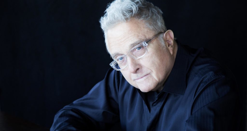 Randy Newman portrait in performance lighting