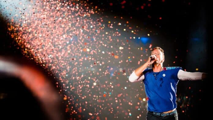 Singer performing in blue shirt