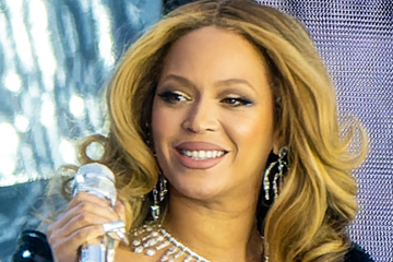 Beyoncé smiling with mic during NFL