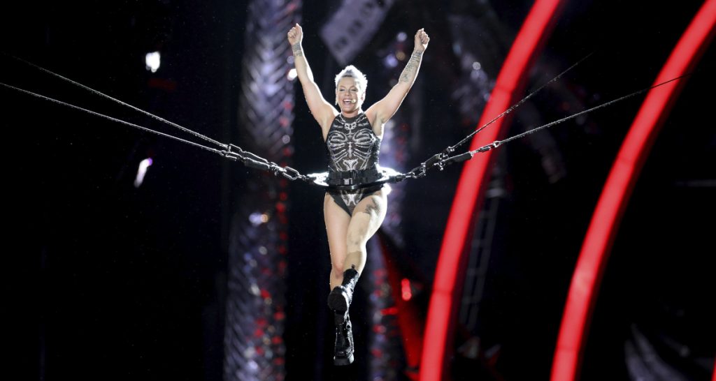 Pink performing aerial acrobatics onstage