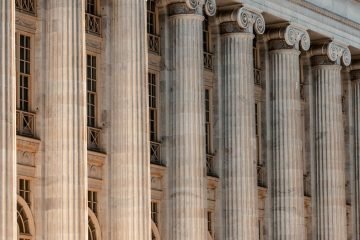 Classical columns with historic building backdrop