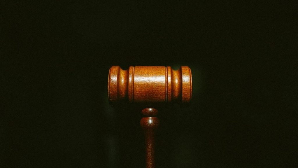 Wooden gavel on court desk surface