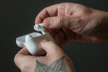 Hand holding Apple AirPods