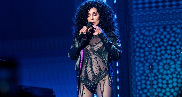 Cher in black performing onstage