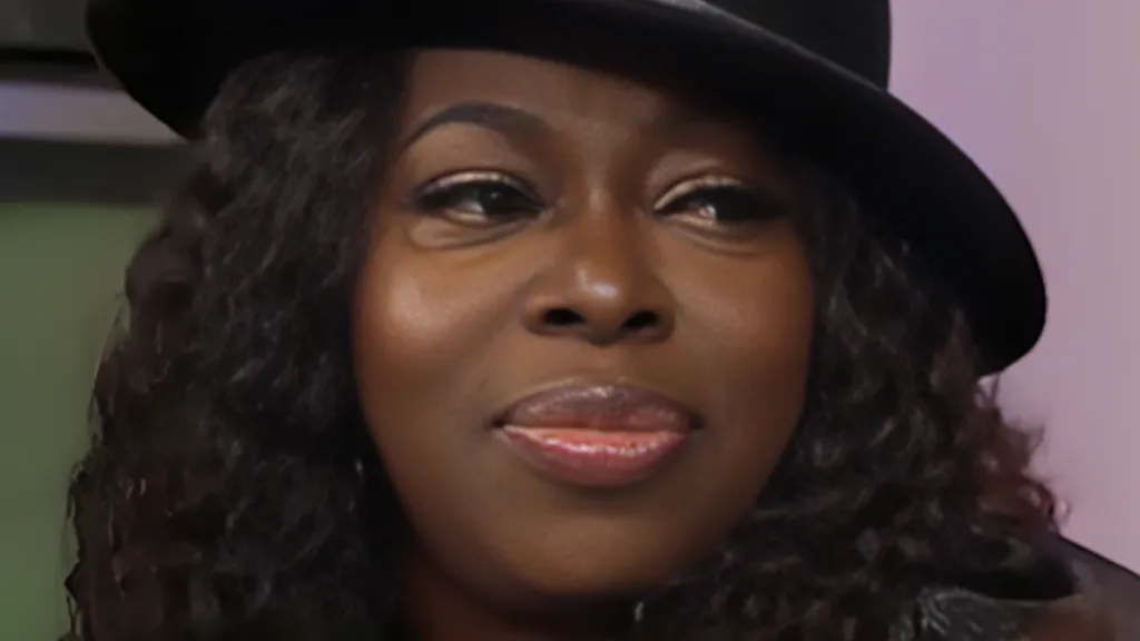 Singer Angie Stone wearing black hat